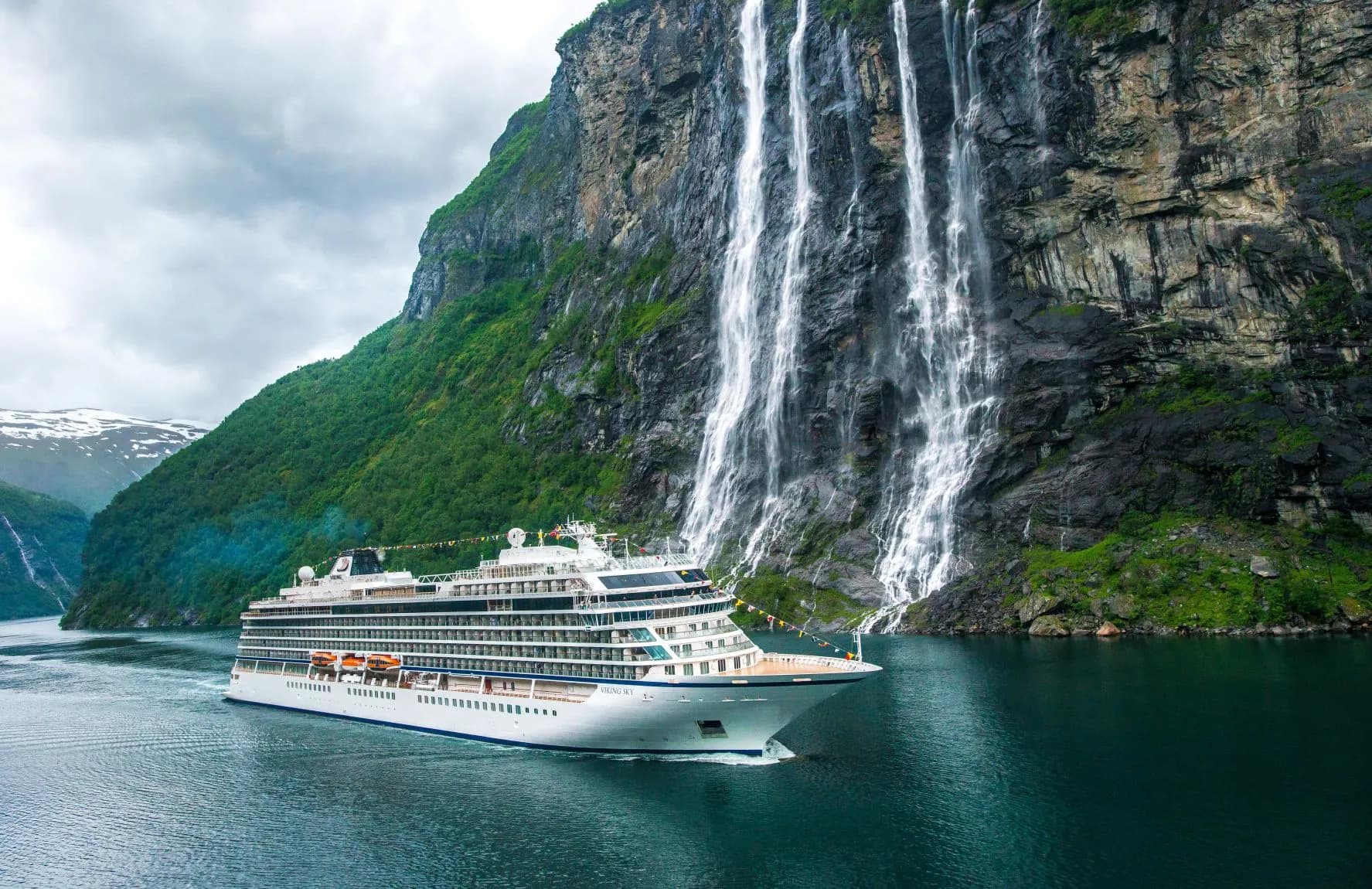 Viking ocean cruise ship sailing past seven sisters waterfalls in Norway Fjords