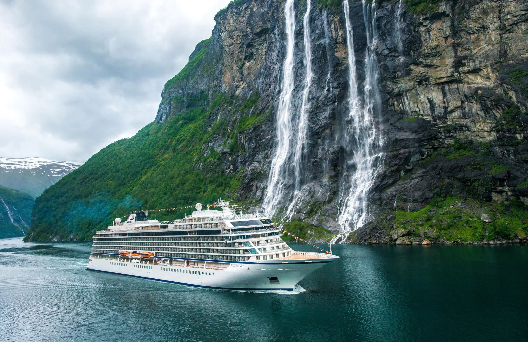 Viking ocean cruise ship sailing past seven sisters waterfalls in Norway Fjords